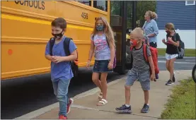  ??  ?? Students get off the school bus at Caroline Street Elementary School in Saratoga Springs on the first day of the 2021-2022school year.