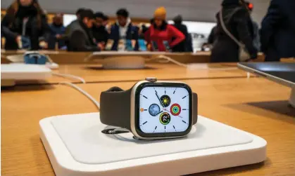  ?? ?? An Apple smartwatch is displayed as customers visit the Apple store in New York, 26 December 2023. Photograph: Eduardo Muñoz/ Reuters