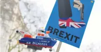  ?? PHOTO: REUTERS ?? Conveying a message . . . AntiBrexit protesters hold up a sign and a model prop boat outside Downing Street in London yesterday.