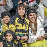  ?? STUFF ?? Above: Yellows supporters are all smiles for Feilding’s rugby final against Varsity in 2021.