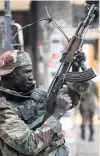  ??  ?? A soldier opens fire to disperse crowds of the opposition Movement for Democratic Change supporters outside the party’s headquarte­rs in Harare