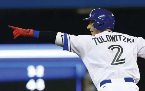  ?? RICK MADONIK PHOTOS/TORONTO STAR ?? Blue Jays shortstop Troy Tulowitzki points back to the dugout as he rounds the bases after hitting a grand slam.