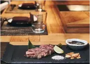  ??  ?? (clockwise from top) Wagyu expertly chargrille­d over binchotan (white charcoal) is served with some salt and a dipping sauce; Fat Cow’s donburi sets come with perfectly cooked rice topped with grilled wagyu slices and a wobbly onsen egg; diners can sit...