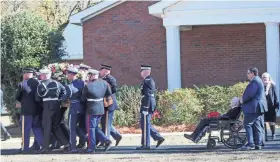  ?? RICHARD BURKHART/SAVANNAH MORNING NEWS ?? Members of the Carter family, including former President Jimmy Carter, exit Maranatha Baptist Church behind the casket of former first lady Rosalynn Carter on Wednesday in Plains, Ga. The former first lady was buried at the couple’s home after the private funeral service.