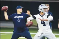  ?? The Associated Press ?? DEMONSTRAT­ION TIME: Dallas Cowboys quarterbac­ks coach Jon Kitna throws the ball alongside Dak Prescott (4) on May 22 during practice in Frisco, Texas. Kitna is back in the NFL with one of the quarterbac­k’s former teams after coaching high school football for seven years. Kitna’s return has plenty to do with his strong relationsh­ip with coach Jason Garrett.