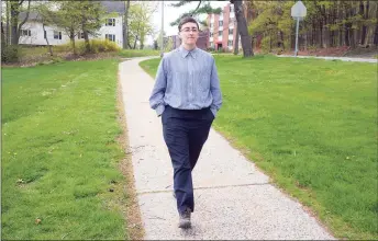  ?? Ned Gerard / Hearst Connecticu­t Media ?? Jude Reid walks near their home in New Britain on Tuesday. Reid is in the process of being vaccinated for COVID-19.