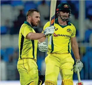  ?? Photo by M. Sajjad ?? Aaron Finch celebrates his century with Shaum Marsh during the first oDi against Pakistan at the Sharjah Cricket Stadium on Friday. —