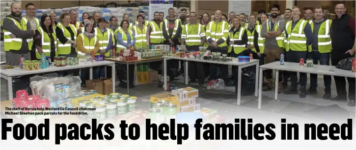  ??  ?? The staff of Kersia help Wexford Co Council chairman Michael Sheehan pack parcels for the food drive.