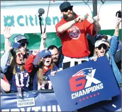  ??  ?? LEFT: New England Patriots owner Robert Kraft, left, and son Jonathan Kraft hold up their team’s Super Bowl trophies during the team’s victory Duck Boat Parade Tuesday in downtown Boston.