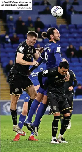  ?? HUW EVANS AGENCY ?? > Cardiff’s Sean Morrison in an aerial battle last night