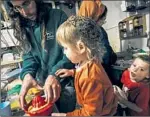  ?? ?? YISHAI SHEINMAN, at home with his children in the West Bank settlement of Yitzhar, is a member of a violent extremist group seeking to expand Israeli control over the region.