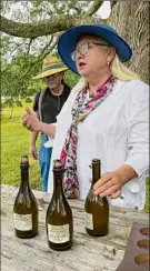  ??  ?? Elizabeth Ryan of Breezy Hill Orchard discusses her hard cider at Stone Ridge Orchard.