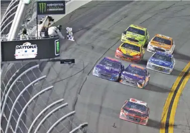  ?? THE ASSOCIATED PRESS ?? Austin Dillon races to the finish line last Sunday to win the Daytona 500. Behind him, Bubba Wallace, left, and Denny Hamlin make contact as they fight for second place. Wallace wound up second and took a dig at Hamlin after the race.