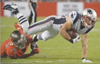  ?? The Associated Press ?? New England Patriots receiver Danny Amendola is tripped up by Tampa Bay Buccaneers cornerback Brent Grimes during second-quarter NFL action on Thursday in Tampa, Fla. The Patriots won 19-14.