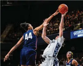  ?? Terrance Williams/Associated Press ?? Georgetown guard Kelsey Ransom has her shot blocked by UConn forward Aubrey Griffin during the second half on Saturday in Washington.