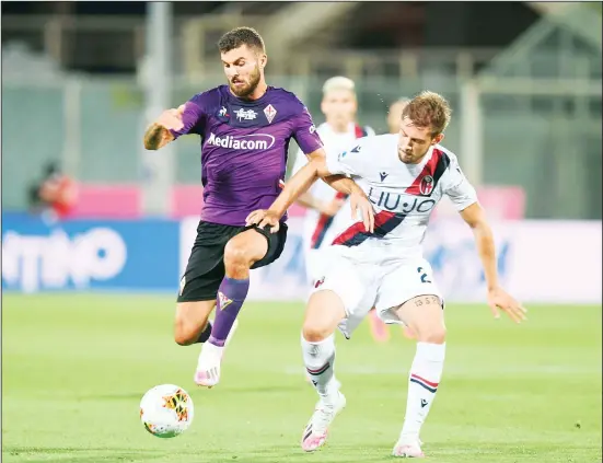  ??  ?? Fiorentina’s Patrick Cutrone (left) and Bologna’s Gabriele Corbo compete for the ball during a Serie A soccer match between Fiorentina and Bologna, at the Artemio Franchi stadium in Florence,
Italy, July 29. (AP)