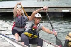  ?? ?? Coach and breast cancer survivor Sonia “Crash” Rogers, of Crafton, front, teaches new paddler Sarah McKean, of Shadyside some basics prior to a practice session Tuesday on the Allegheny River.