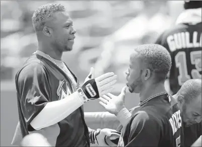  ?? By Patrick Semansky, AP ?? Dynamic duo: Hanley Ramirez, left, moved to third base when the Marlins acquired former Mets shortstop Jose Reyes in free agency. “I feel really happy at third,” Ramirez said. “If I had known that, I would have changed before.”