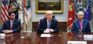  ?? The Associated Press ?? LOOMING DEADLINES: House Speaker Paul Ryan, R-Wis., left, and Senate Majority Leader Mitch McConnell, R-Ky., right, listen as President Donald Trump speaks Sept. 5 during a meeting with Congressio­nal leaders and administra­tion officials on tax reform,...