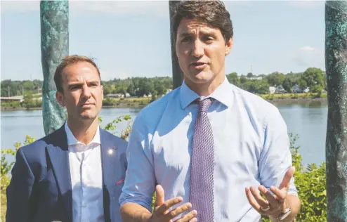  ?? STEPHEN MACGILLIVR­AY / THE CANADIAN PRESS ?? Prime Minister Justin Trudeau speaks with media on Thursday along the Saint John River as member of Parliament for Fredericto­n Matt
DeCourcey looks on. Trudeau was in Fredericto­n to discuss federal funding for flood mitigation.