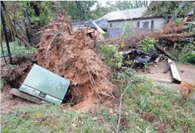  ??  ?? A utility box is left damaged after being moved by an uprooted tree Monday on Woodford Lane near Brierbrook Road in Germantown.