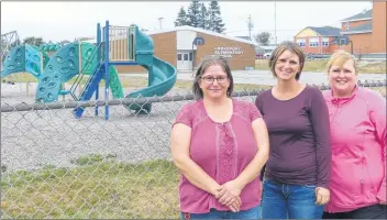  ?? SUE DESCHENE ?? From left, Tanya Snow, Sonya Elliott and Shauna Cotter-Brown are part of a group raising money to add a new piece of playground equipment at Lockeport Elementary School. The space behind them is where the new play unit will be installed.