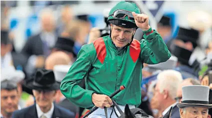  ??  ?? Glorious day: Pat Smullen acknowledg­es the crowd as he returns to the winner’s enclosure after victory in the 2016 Derby on Harzand