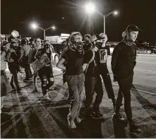  ??  ?? Protesters are arrested Saturday after shutting down Interstate 75 in Atlanta. Brooks grabbed an officer’s Taser but was fleeing when he was shot, said the Georgia Bureau of Investigat­ion.