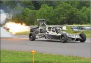  ?? PETE BANNAN — DIGITAL FIRST MEDIA ?? Dan Marcotte guides his jet car down the runway at New Garden airport during the 12th Annual Chester County Balloon Festival. The General Electric J-85 engine comes out of a F 5 Freedom fighter jet and reaches speed of 250-300 mph. “It can go faster than the chute and tire capabiliti­es,” said Marcotte, who wears full safety gear of helmet, fire suit and gloves in the custom-built car.