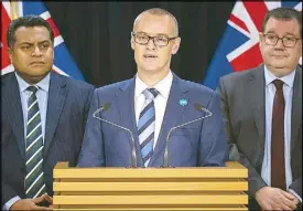  ?? AP ?? New Zealand Health Minister David Clark (center), flanked by Cabinet colleagues Grant Robertson (right) and Kris Faafoi, addresses a press conference where he announced his resignatio­n at parliament in Wellington yesterday.