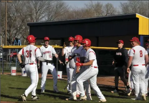  ?? Photo by Mike Frank ?? Landon Brandt of Wapakoneta (#35) is congratula­ted by his teammates after hitting a home run in the third inning of Tuesday’s game at St. Marys.