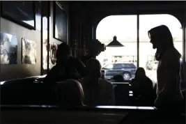  ?? MATT ROURKE — THE ASSOCIATED PRESS ?? Republican presidenti­al candidate former UN Ambassador Nikki Haley, right, meets with patrons during a campaign stop at Mary Ann’s Diner in Derry, N.H., Sunday.