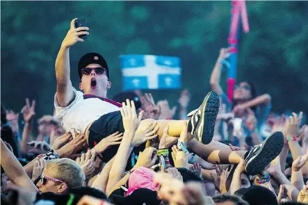  ?? DARIO AYALA/ THE GAZETTE ?? A crowdsurfe­r enjoys last summer’s Osheaga. The festival, now in its ninth year, runs Aug. 1 to 3 and is expected to draw 135,000 music lovers.