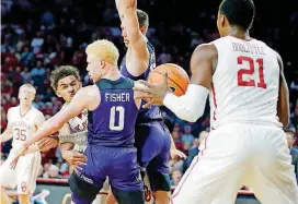  ?? [PHOTO BY BRYAN TERRY, THE OKLAHOMAN] ?? Oklahoma’s Trae Young passes the ball to Kristian Doolittle during Saturday’s overtime win over TCU at Lloyd Noble Center. Doolittle has come on strong recently as he works his way back into the rotation.