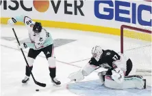  ?? MARTA LAVANDIER, AP ?? Pacific Division’s Elias Pettersson, of the Vancouver Canucks, scores against Central Division goaltender Connor Hellebuyck, of the Winnipeg Jets, in Sunrise, Florida, on Saturday.