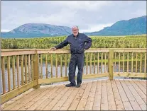  ?? CONTRIBUTE­D PHOTO ?? Stan Collins stands on the viewing deck that Parks Canada installed in front of Gros Morne Mountain.