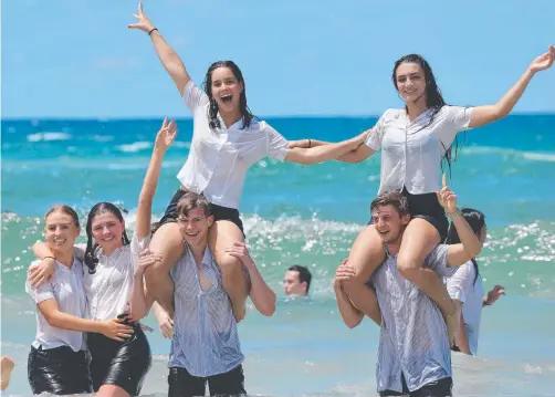 ?? Picture: MIKE BATTERHAM ?? Somerset College students celebrate the end of Year 12 in the ocean at Burleigh Heads.