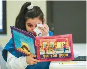  ?? JOSE M. OSORIO/CHICAGO TRIBUNE ?? Detainee Samantha Estrada, 28, tears up as she reads from the book “See You Soon” by Mariame Kaba at Cook County Jail in Chicago on Thursday.