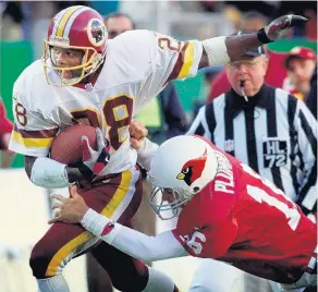  ?? DOUG MILLS/ASSOCIATED PRESS FILE ?? Darrell Green grabs his 50th career intercepti­on off Arizona Cardinals quarterbac­k Jake Plummer. Green entered the Hall of Fame in 2008.