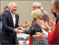  ?? Arkansas Democrat-Gazette/STEPHEN B. THORNTON ?? Gov.-elect Asa Hutchinson greets supporters as he is introduced at the Arkansas Republican Party State Committee meeting Saturday in Benton.