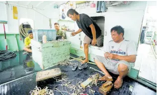  ?? AP ?? Foreign helpers do some maintenanc­e work on their fishing tools while sitting on their boat docked at the Tomari fishery port in Naha in the main Okinawa island, southern Japan, on June 1, 2023. The Japanese government on Friday adopted plans to scrap its current foreign trainee programme.