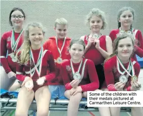  ??  ?? Some of the children with their medals pictured at Carmarthen Leisure Centre.