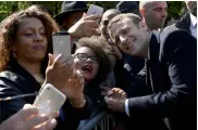  ?? — AFP ?? French President-elect Emmanuel Macron poses for pictures with supporters during a ceremony to mark the anniversar­y of the abolition of slavery at the Jardins du Luxembourg, in Paris, on Wednesday.