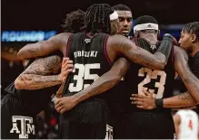  ?? Brett Coomer/staff photograph­er ?? Texas A&M players had to pull together Sunday night to force overtime after falling behind Houston.