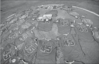  ?? MARCIO JOSE SANCHEZ/AP PHOTO ?? Jerseys with pitcher Tyler Skaggs’ number are placed on the mound after the Los Angeles Angels completed a combined no-hitter against the Seattle Mariners in Friday night’s game at Anaheim, Calif.