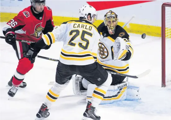  ?? ASSOCIATED PRESS ?? UP IN THE AIR: Bruins defenseman Brandon Carlo, goalie Tuukka Rask and Senators center Colin White watch as a loose rebound floats in front of the net their game on Wednesday night.