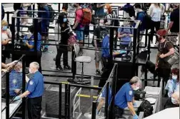  ?? Will Waldron / Times Union ?? Passengers head through the security checkpoint Wednesday at Albany Internatio­nal Airport in Colonie. Sen. Charles E. Schumer was at the airport Wednesday stumping for a $1 trillion infrastruc­ture plan that would bring nearly $29 million in improvemen­ts to the airport.