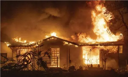  ??  ?? A house burns on Platina Road at the Zogg Fire near Ono, California, 27 September 2020. Photograph: Ethan Swope/AP