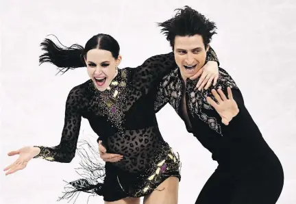 ?? ARIS MESSINIS/AFP/GETTY IMAGES ?? Tessa Virtue and Scott Moir scored a world record 83.67 points in the ice dance short program Sunday night.