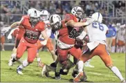  ?? Danielle Pickett, General Photograph­y ?? Heritage lineman Jake Cobb throws a block to help spring running back Paxton Mccrary for a big gain, while fellow lineman J.T. Eaton (left) moves in to assist.